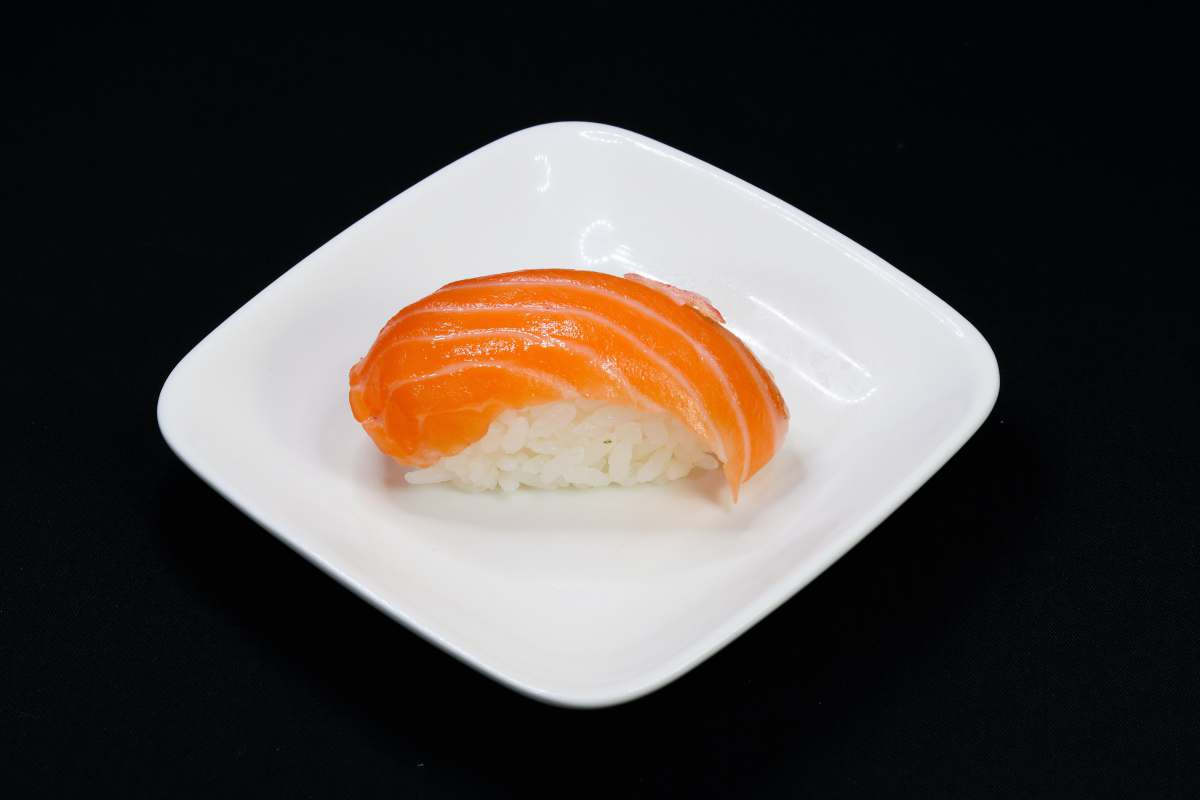 raw fish orange and white bread on white ceramic plate japanese food